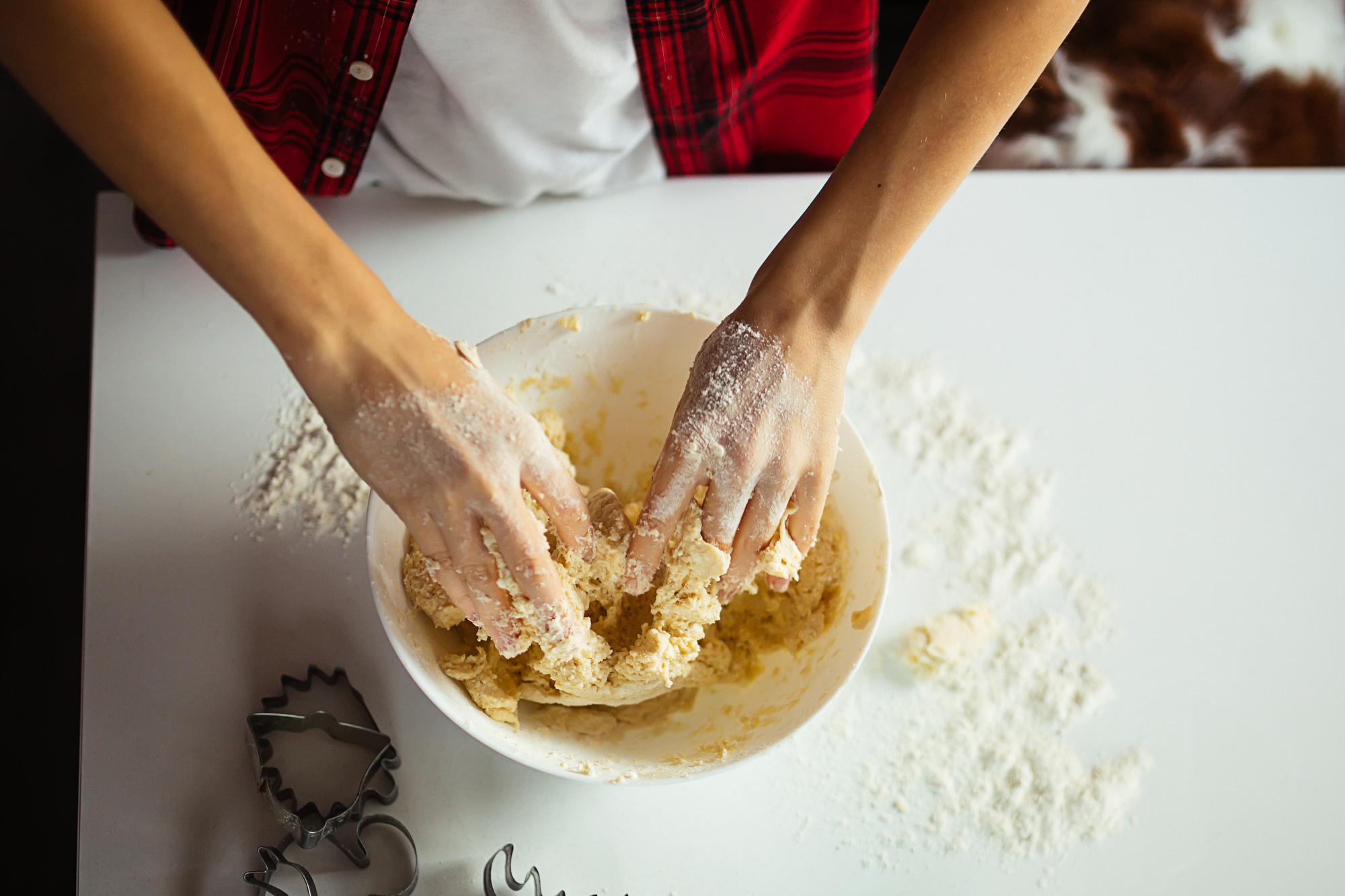 Close-up of hands preparing dough